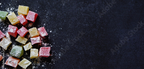 Colorful Traditional Turkish Delight on black background with a copy space on right photo