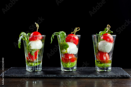 Canapes of tomatoes and cheese in a glass. Three cups.