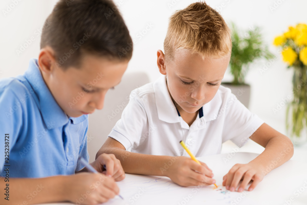 Little boys having fun and coloring at home Little boys having fun and coloring at home