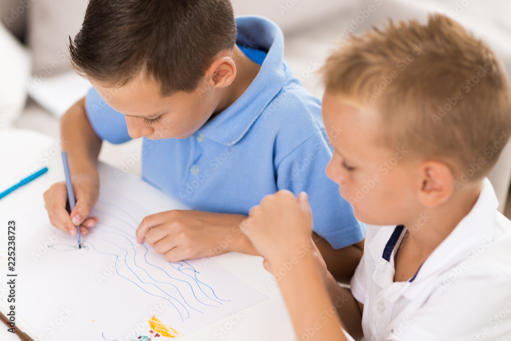 Little boys having fun and coloring at home Little boys having fun and coloring at home