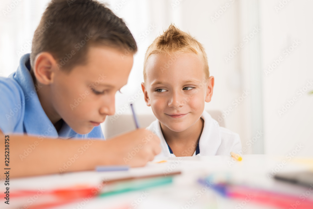 Little boys having fun and coloring at home Little boys having fun and coloring at home