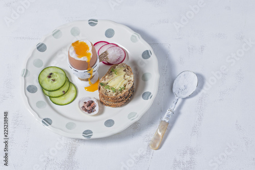 Boiled Eggs and Wholemeal Bread  and Vegetables on White Rustic Background