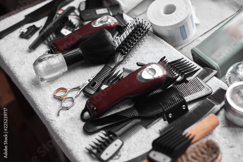Barber tools on a white towel. Scissors, a razor, and other hairdressing tools.