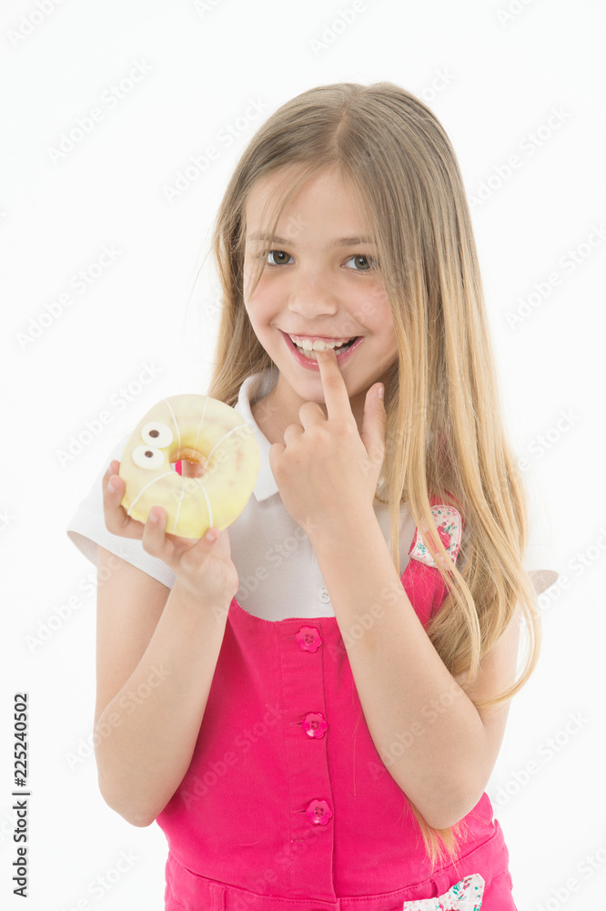 Treats for holidays. Kid rewarded for good behavior with sugary treats. Girl cute smiling face holds sweet donut. Girl likes sweets as donuts. How tame childs sweet tooth. Treats and dieting concept Treats for holidays. Kid rewarded for good behavior with sugary treats. Girl cute smiling face holds sweet donut. Girl likes sweets as donuts. How tame childs sweet tooth. Treats and dieting concept