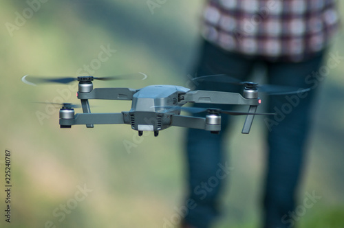 closeup of small drone for video application in outdoor with pilot on background