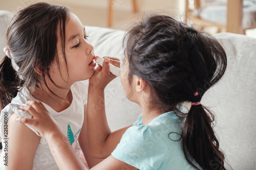 young multicultural kids doing make up pretend play