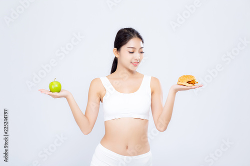 Beautiful asian woman slim shape with diet choosing fresh salad vegetable and hamburger isolated on white background, healthy with control for weight loss, nutrition and lifestyle concept.