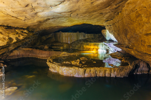 Beautiful natural cave. Cascades of underground lakes in Nizhneshakuranskaya cave, Abkhazia, Georgia