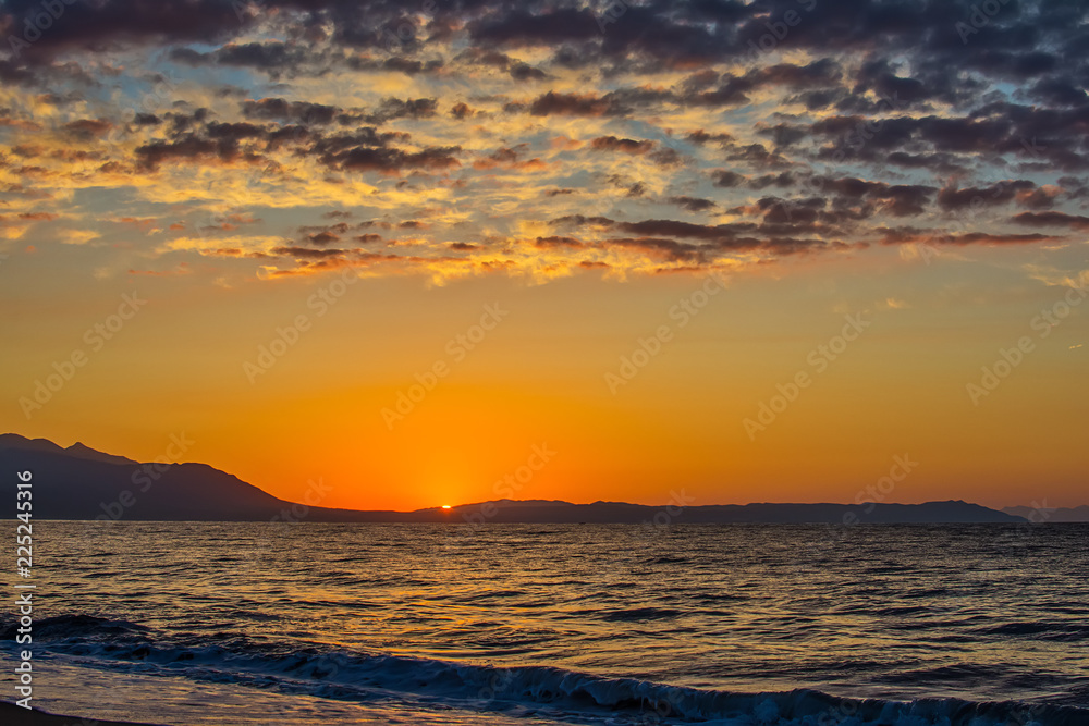 Naklejka premium Early morning , dramatic sunrise over sea and mountain. Photographed in Asprovalta, Greece.