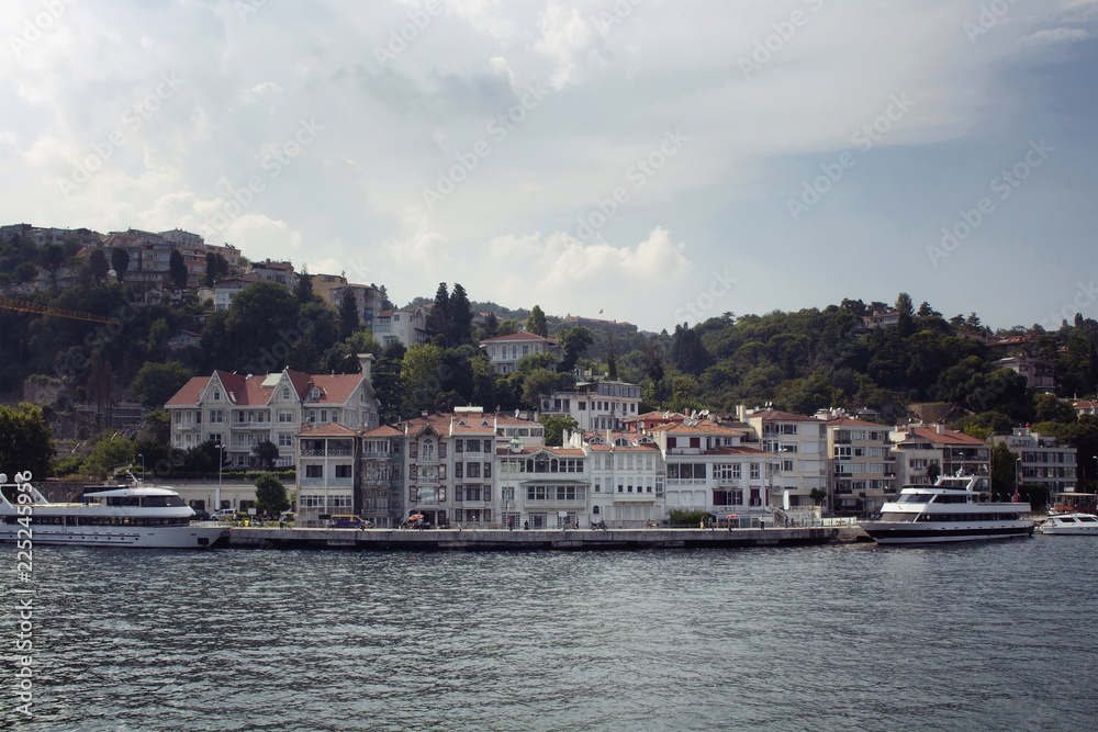 View of big motorboats, buildings on European side and Bosphorus in Istanbul.