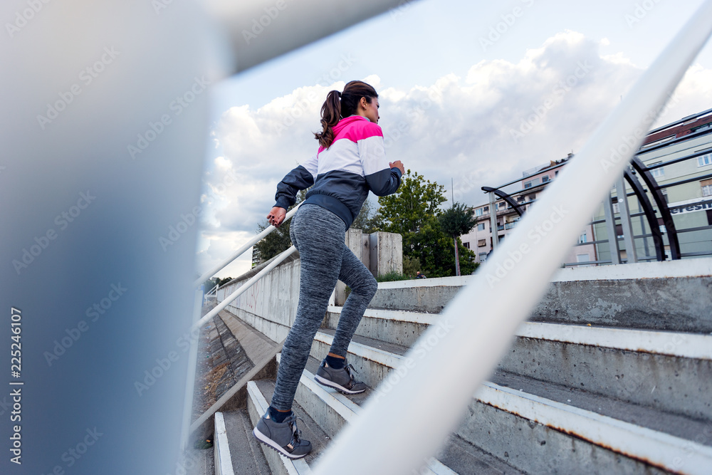 Fitness woman running up the stairs