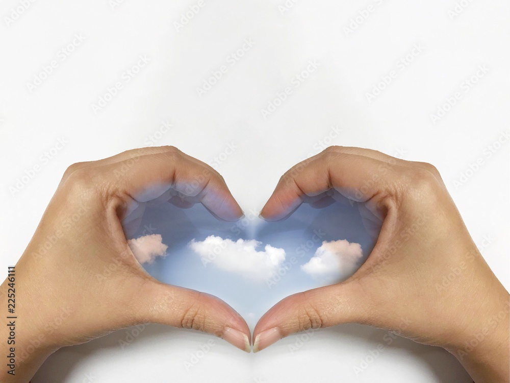 Obraz premium Sky in woman hand heart shape on white background