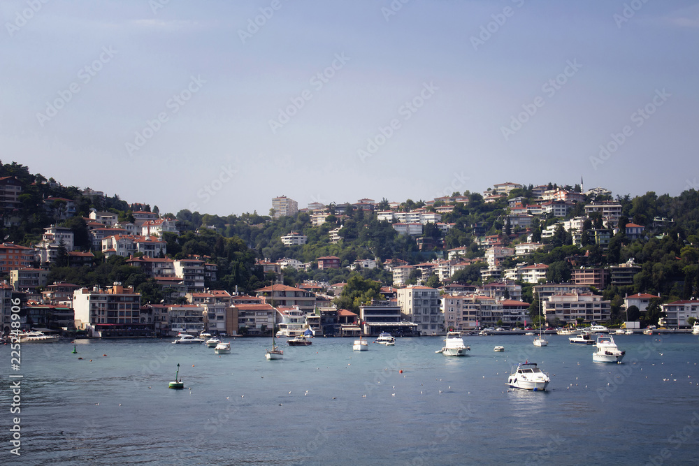 View of motorboats and yachts, buildings on European side and Bosphorus in Istanbul. It is a sunny summer day. View of motorboats and yachts, buildings on European side and Bosphorus in Istanbul. It is a sunny summer day.
