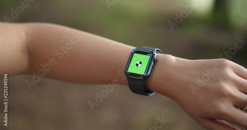 Woman using her green screen smart watch