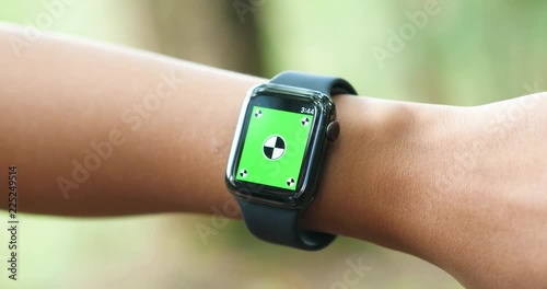 Woman using her green screen smart watch