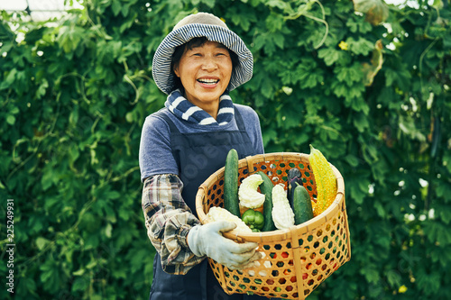 Portrait of woman with basket of vegetables photo