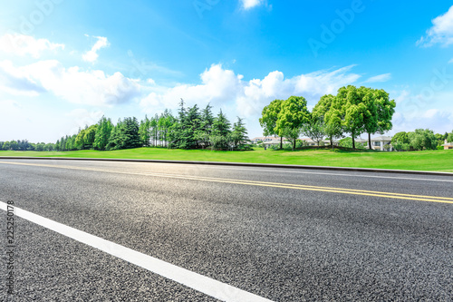 Asphalt highway and green forest natural scenery under the blue sky