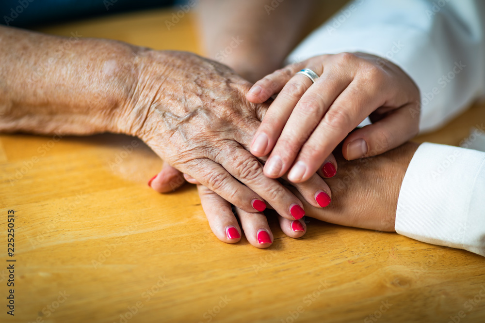 Younger Female Hands Holding Senior Adult Woman Hands Younger Female Hands Holding Senior Adult Woman Hands