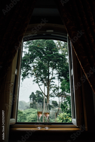 Two glasses of rose wine at the window