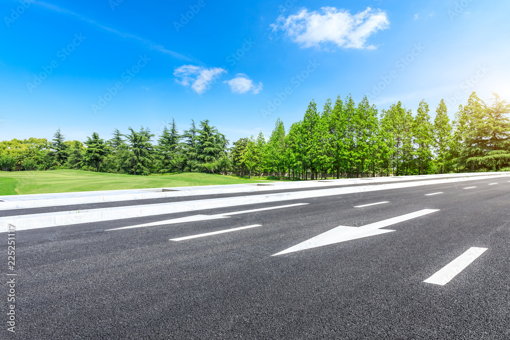 Fototapeta premium Asphalt highway and green forest natural scenery under the blue sky