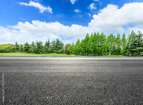 Asphalt highway and green forest natural scenery under the blue sky