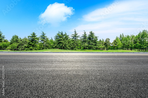 Asphalt highway and green forest natural scenery under the blue sky