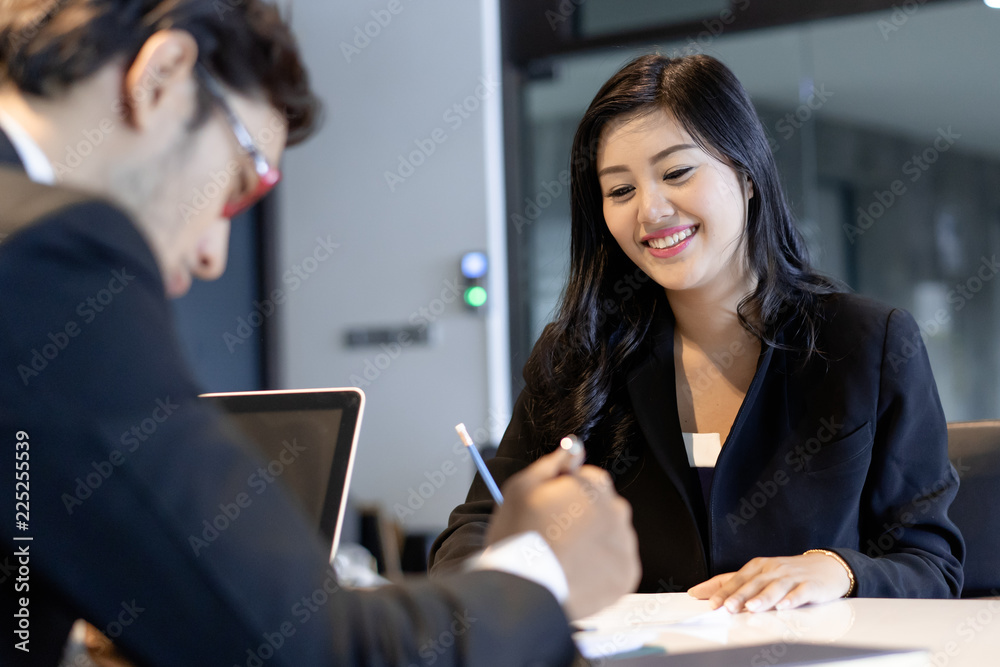 © Pormezz - Asian woman answering question interview during job application.