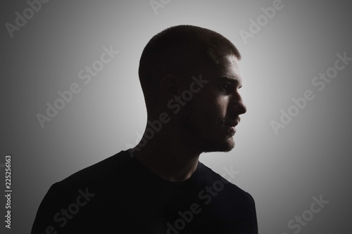 Canvas-taulu one young man, 20-25 years, moody dark portrait, profile