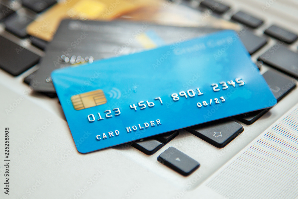 Pile of credit cards on the laptop keyboard. Open access for online shopping Pile of credit cards on the laptop keyboard. Open access for online shopping