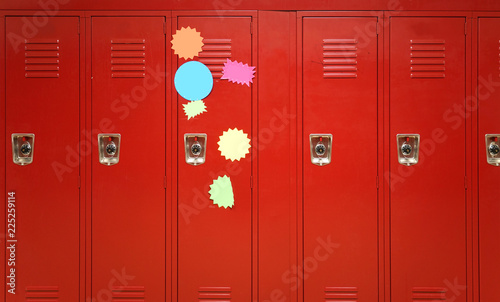 Colorful stickers on red lockers in the school