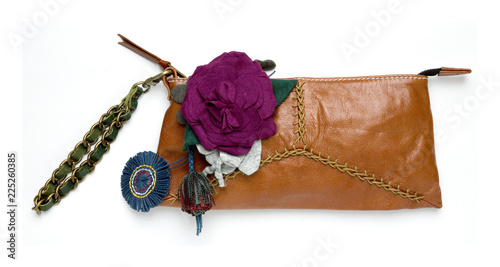 Valokuva Leather wristlet bag with fabric flowers decoration, isolated on white background with clipping mask