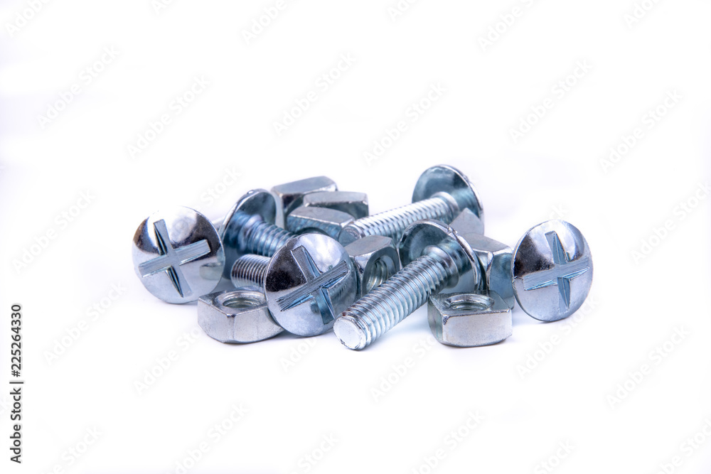 Stainless steel nuts and bolts on an isolated white background.