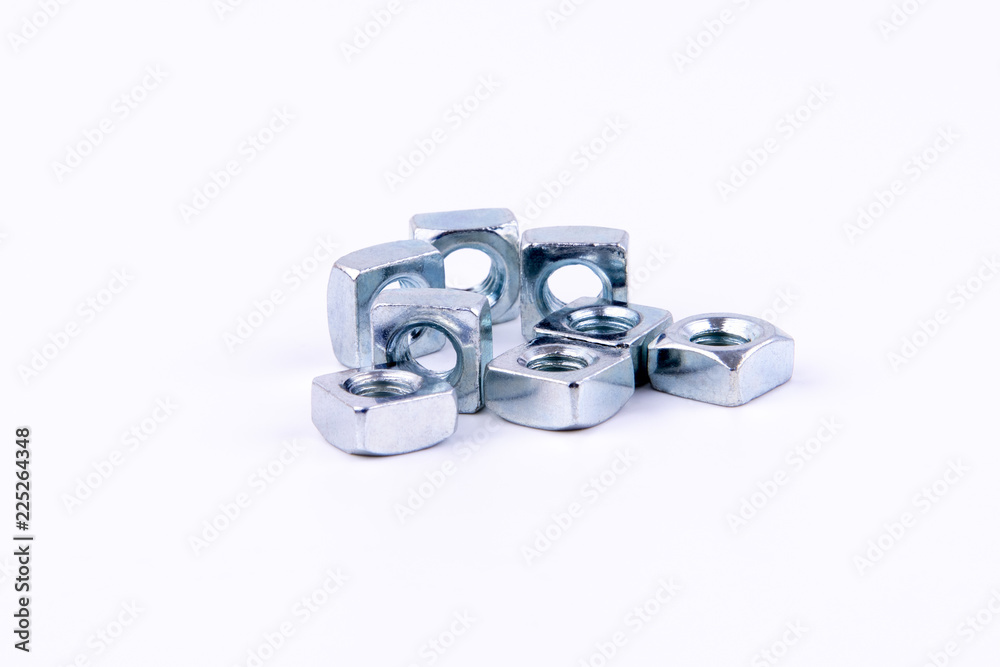 Stainless steel nuts on an isolated white background. Stainless steel nuts on an isolated white background.