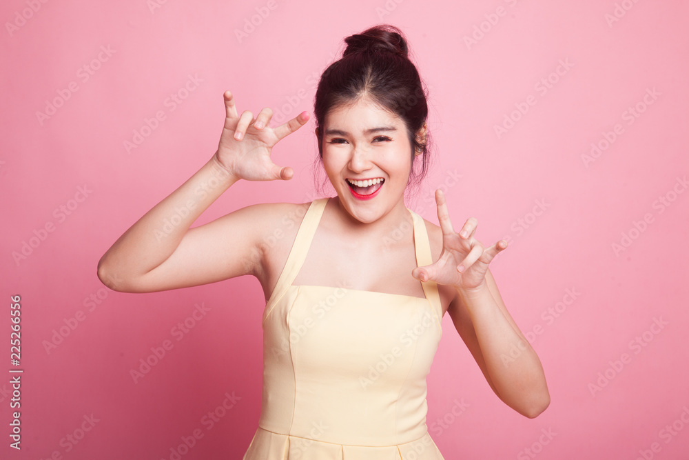 Young Asian woman with spooky hands gesture. Young Asian woman with spooky hands gesture.