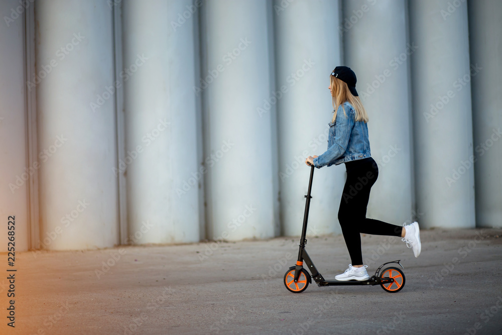 Beautiful young woman riding a scooter Beautiful young woman riding a scooter