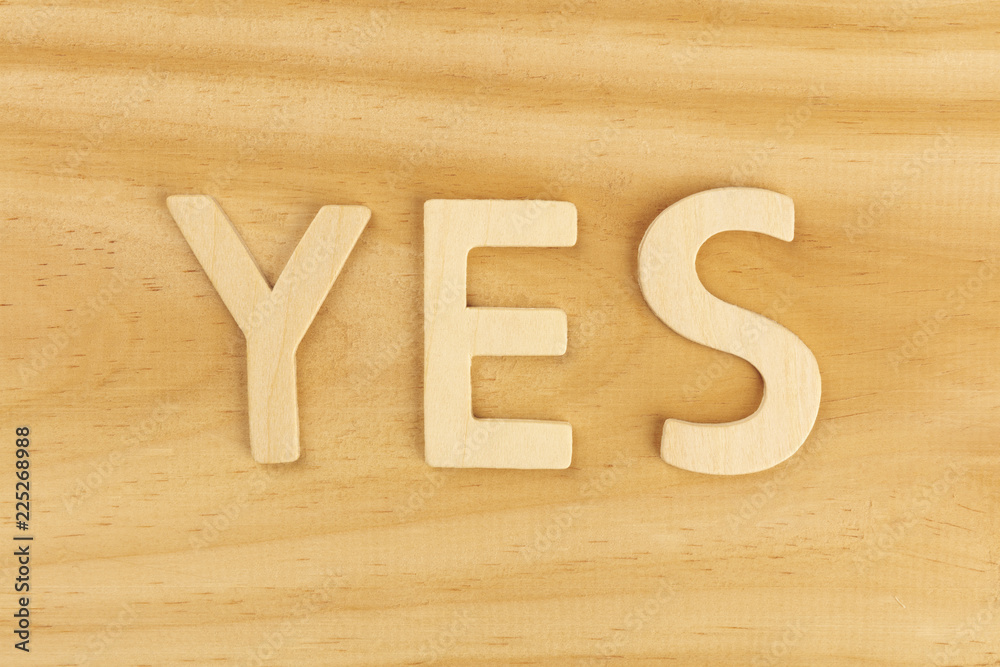 Yes, letters forming word on a wooden background with copy space Yes, letters forming word on a wooden background with copy space