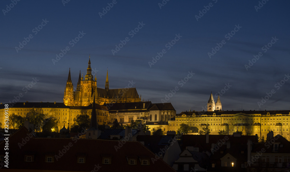 Night view of illuminated St. Vitus Cathedral gothic churche and Prague Castle panorama with hradcany, dark blue sky.