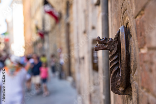 Decorative iron rings and sculpture inset into the walls in Siena Tuscany, used for holding torches photo