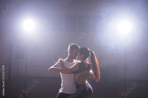 Young couple dancing latin dance Bachata, merengue, salsa. Two elegance pose in dance class