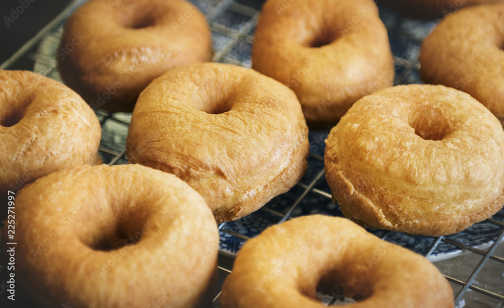 Fried donuts on a cooling rack Fried donuts on a cooling rack