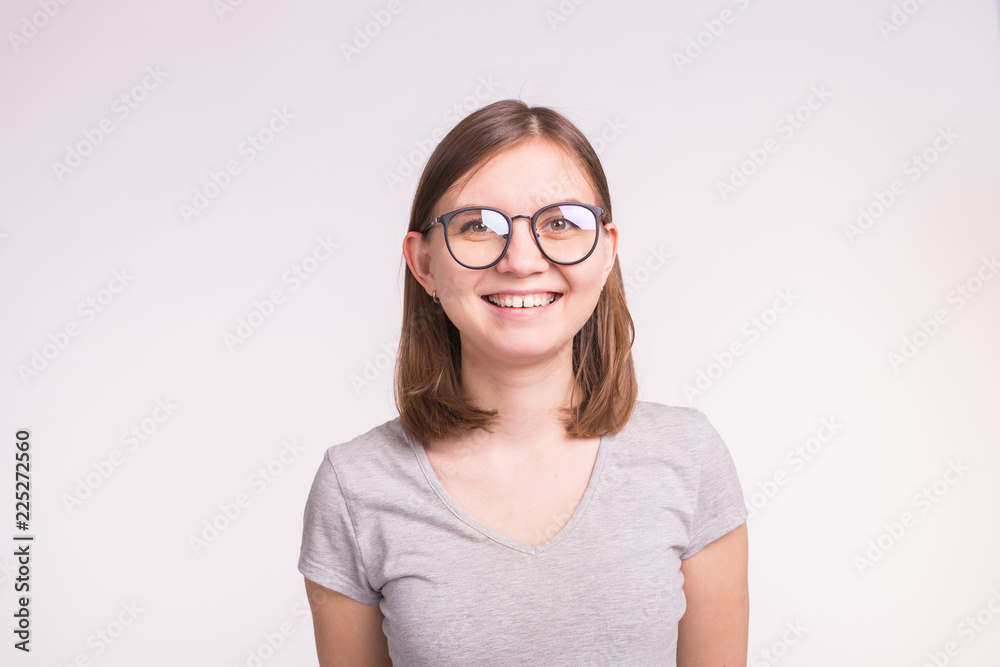 Portrait of white young funny woman with short brown hair in a glasses.