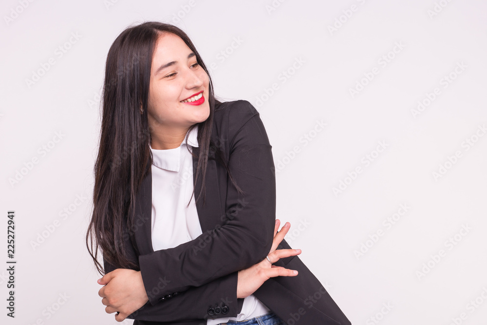 Asian young woman with red lips wearing black suit in white background with copy space Asian young woman with red lips wearing black suit in white background with copy space