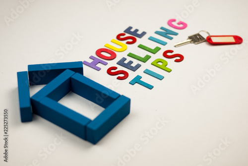 House model and wooden alphabet with text house selling tips