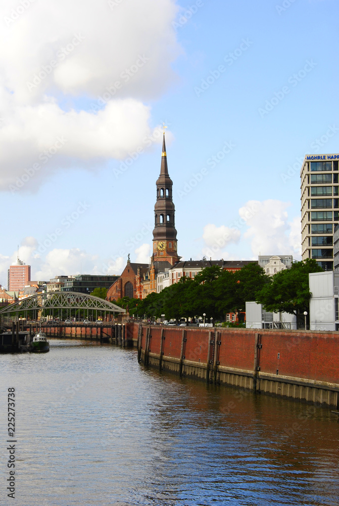 Fototapeta premium Mainchurch St. Cathrine in Hamburg in Germany near a canal in the famous Speicherstadt