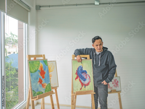 Handsome Young Asian man or water color artist Teaching how to paint in studio