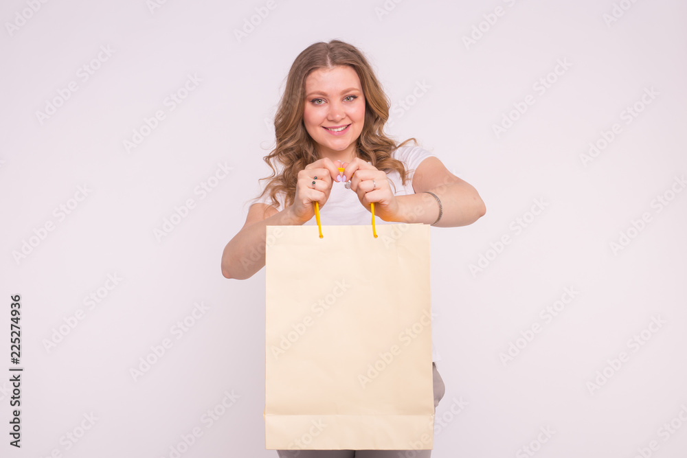 People, sale and consumerism concept - Beautiful woman over white background holding shopping bags People, sale and consumerism concept - Beautiful woman over white background holding shopping bags