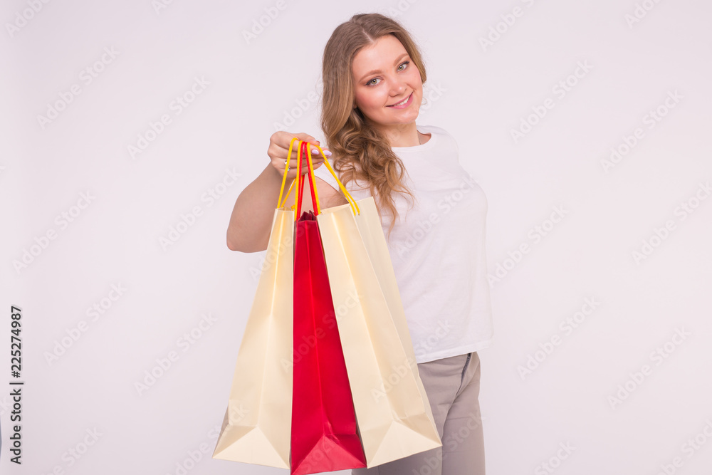 Smiling blonde woman with shopping bags on white background Smiling blonde woman with shopping bags on white background