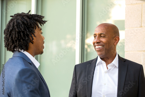 Slika na platnu Mature African American casually dressed businessman shaking hands