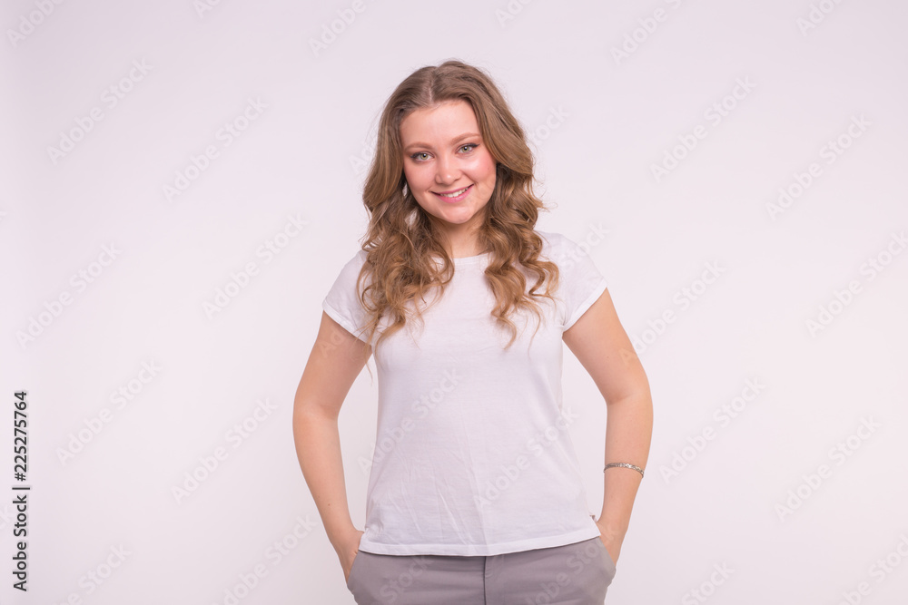 Fashion, style and people concept - pretty young woman dressed in white shirt over white background Fashion, style and people concept - pretty young woman dressed in white shirt over white background