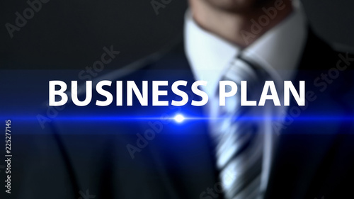 Business plan, male in suit standing in front of screen business development